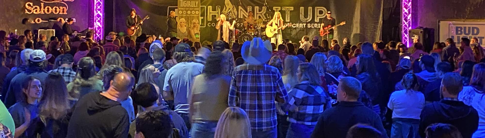 country concert with fans wearing cowboy hats Buffalo