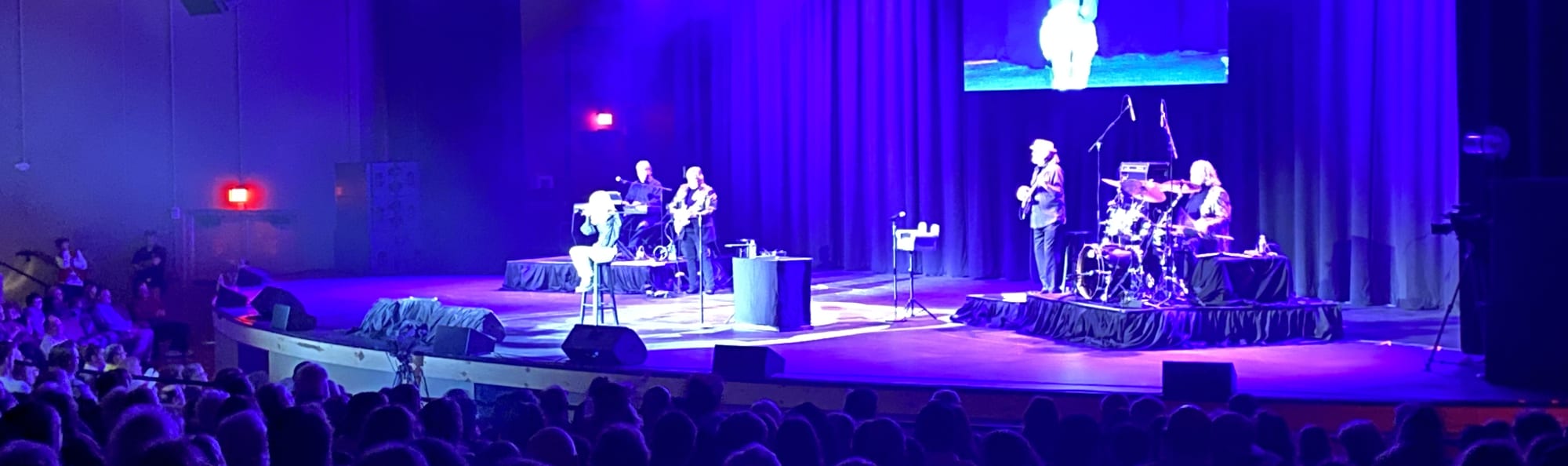 signer on stage in chair washed out by the lights Buffalo